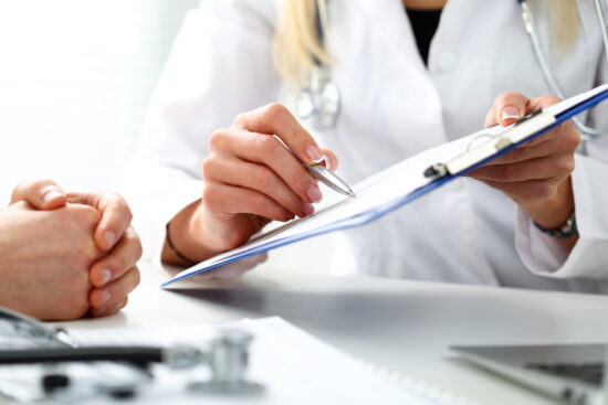 doctor helping patient with forms. 