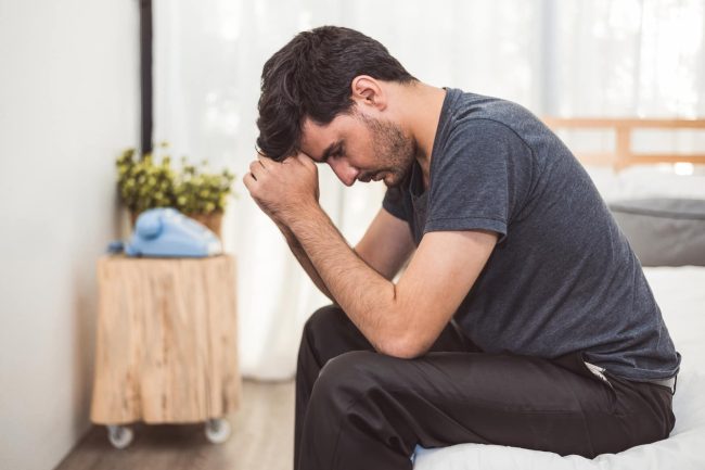 man dealing with discomfort fromScrotal Masses.